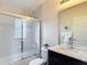 Bathroom with tiled shower, a toilet, and vanity with marble countertop and dark wood cabinet at 13321 Norman Cir, Hudson, FL 34669