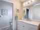 The bathroom features a vanity with drawers and a large mirror, with an adjacent toilet room at 13321 Norman Cir, Hudson, FL 34669