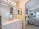 Bathroom view showing a vanity with a large mirror and a doorway view into the bedroom at 13321 Norman Cir, Hudson, FL 34669