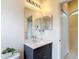 Bathroom with marble countertop vanity and a large mirror showing the doorway to the shower at 13321 Norman Cir, Hudson, FL 34669