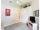 Bedroom with neutral carpet, ceiling fan, large double door closet and small television at 13321 Norman Cir, Hudson, FL 34669