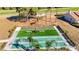 Aerial view of a manicured bocce ball court with benches and a small shaded picnic table at 13321 Norman Cir, Hudson, FL 34669
