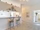 Open breakfast bar area, connecting to a hallway and a bright white kitchen at 13321 Norman Cir, Hudson, FL 34669