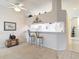 Breakfast bar area, with barstool seating, that connects to the white kitchen at 13321 Norman Cir, Hudson, FL 34669