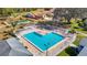 Aerial view of a community pool with ample seating, manicured landscaping, and recreational area at 13321 Norman Cir, Hudson, FL 34669