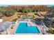 Aerial view of a community pool with ample seating, manicured landscaping, and recreational area at 13321 Norman Cir, Hudson, FL 34669