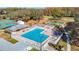 Aerial view of a community pool with ample seating, manicured landscaping, and recreational area at 13321 Norman Cir, Hudson, FL 34669