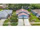 Charming blue home with a two-car garage, landscaped front yard, and mature landscaping at 13321 Norman Cir, Hudson, FL 34669