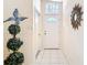 Bright foyer with tile flooring, elegant decorations, and a view of the front door at 13321 Norman Cir, Hudson, FL 34669