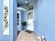 Welcoming front porch featuring a decorative door, tile flooring, and serene blue walls at 13321 Norman Cir, Hudson, FL 34669