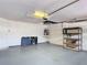 Clean garage offers storage with shelving and cabinets and room for vehicles at 13321 Norman Cir, Hudson, FL 34669
