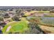 Aerial view of a lush golf course with ponds, mature trees, and neatly manicured greens at 13321 Norman Cir, Hudson, FL 34669