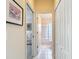 Hallway view shows access to the bedroom, storage closets, and a bathroom with a shower at 13321 Norman Cir, Hudson, FL 34669