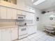 Bright kitchen features a skylight, white cabinets, and modern appliances at 13321 Norman Cir, Hudson, FL 34669