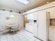 Open-concept kitchen boasts white appliances, tiled floors, and a breakfast nook at 13321 Norman Cir, Hudson, FL 34669