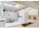 Bright kitchen featuring white appliances, tile floor, skylight, and an eat-in area at 13321 Norman Cir, Hudson, FL 34669