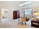 Bright living room featuring plush carpeting, skylights, comfortable seating and access to the bedroom at 13321 Norman Cir, Hudson, FL 34669