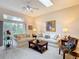 Bright living room with neutral tones, ceiling fan, and skylight offering a relaxing atmosphere at 13321 Norman Cir, Hudson, FL 34669