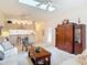 Open living space with high ceilings, skylight, and breakfast bar connecting to the kitchen at 13321 Norman Cir, Hudson, FL 34669