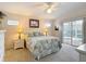 Bright bedroom includes a ceiling fan, and access to the lanai at 13321 Norman Cir, Hudson, FL 34669