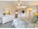 Bright bedroom includes a ceiling fan, and an ensuite bathroom at 13321 Norman Cir, Hudson, FL 34669