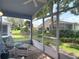 Enclosed patio with outdoor seating overlooking a lush, well-manicured lawn at 13321 Norman Cir, Hudson, FL 34669