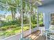 Screened patio providing a peaceful view of the manicured backyard and garden at 13321 Norman Cir, Hudson, FL 34669