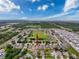 Aerial view of a residential community with homes surrounding a central green space; perfect location with nearby amenities at 14655 Potterton Cir, Hudson, FL 34667