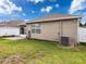 Expansive backyard with well-maintained lawn, patio area, and access to the screened patio at 14655 Potterton Cir, Hudson, FL 34667