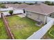 A delightful fenced backyard showcasing a brick-paved patio, lush green lawn, and mature landscaping at 14655 Potterton Cir, Hudson, FL 34667