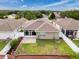 A charming backyard featuring a screened lanai, brick-paved patio, and a well-manicured lawn at 14655 Potterton Cir, Hudson, FL 34667