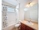 The bathroom has a shower-tub combo with tile surround, sink, and a toilet at 14655 Potterton Cir, Hudson, FL 34667