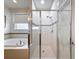 Bright bathroom features a soaking tub and separate shower with decorative tile accents at 14655 Potterton Cir, Hudson, FL 34667