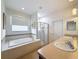 Bright bathroom features a large tub, separate shower, and double sinks for added convenience at 14655 Potterton Cir, Hudson, FL 34667