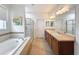 Large bathroom with a separate shower, bathtub, and dual sinks for a spa-like experience at 14655 Potterton Cir, Hudson, FL 34667