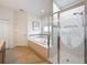 Bright bathroom showcases a separate shower, luxurious tub, and tile floors at 14655 Potterton Cir, Hudson, FL 34667
