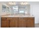 Double vanity with ample counter space, decorative lighting, and a large mirror at 14655 Potterton Cir, Hudson, FL 34667