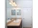 Bathroom featuring a vanity with wood cabinets, large mirror and view of shower in the reflection of the mirror at 14655 Potterton Cir, Hudson, FL 34667