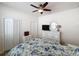 Bright bedroom features a ceiling fan, a window, and a dresser for storage at 14655 Potterton Cir, Hudson, FL 34667