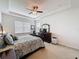 Comfortable bedroom with a ceiling fan, dresser with a TV, and a plush patterned bedspread at 14655 Potterton Cir, Hudson, FL 34667