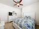 Bright bedroom features a ceiling fan, a window, and a dresser for storage at 14655 Potterton Cir, Hudson, FL 34667