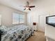 Bright bedroom features a ceiling fan, a window, and a dresser for storage at 14655 Potterton Cir, Hudson, FL 34667