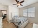Bright bedroom features a ceiling fan, a window, and a dresser for storage at 14655 Potterton Cir, Hudson, FL 34667