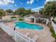Community pool features a spacious deck, covered seating, and a fully fenced perimeter at 14655 Potterton Cir, Hudson, FL 34667