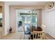 Bright dining area with sliding glass doors leading to a screened patio, perfect for indoor-outdoor living at 14655 Potterton Cir, Hudson, FL 34667