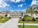 Charming single-story home with a well-manicured lawn, lush landscaping and a two car garage at 14655 Potterton Cir, Hudson, FL 34667