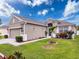 Charming single-story home with a well-manicured lawn, lush landscaping and a two car garage at 14655 Potterton Cir, Hudson, FL 34667