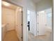Hallway view showing three open doorways to other rooms in the house and tiled flooring at 14655 Potterton Cir, Hudson, FL 34667