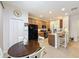 Traditional kitchen with wood cabinets, tile floors, granite countertops, and breakfast bar seating at 14655 Potterton Cir, Hudson, FL 34667