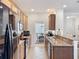 Bright kitchen with tile flooring, recessed lighting, breakfast bar, stainless sink and matching appliances at 14655 Potterton Cir, Hudson, FL 34667